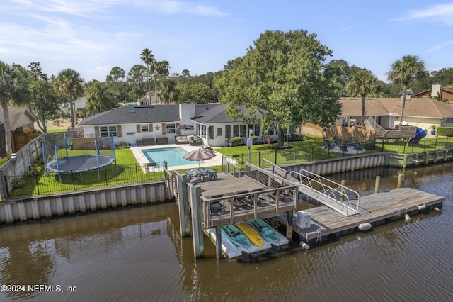 view of dock with a fenced in pool, a lawn, a fenced backyard, a water view, and a patio area