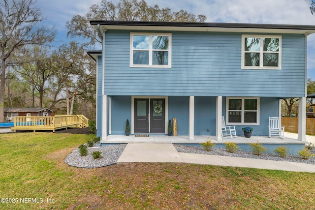 view of front of home with covered porch and a front yard