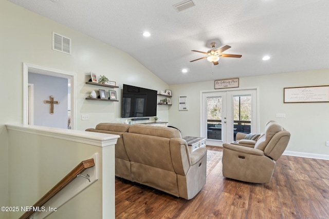 living room with visible vents, vaulted ceiling, dark wood-style flooring, and french doors