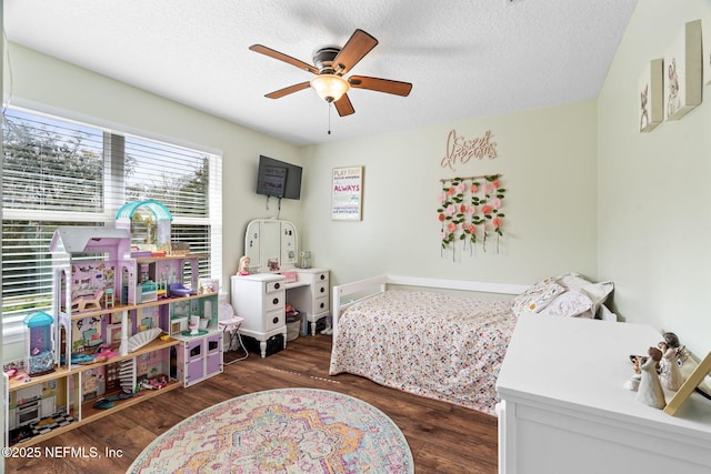 bedroom featuring a textured ceiling, wood finished floors, and a ceiling fan