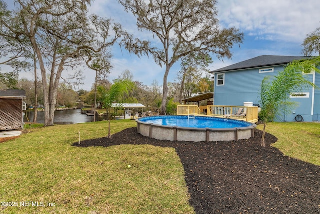 pool featuring a lawn and a water view