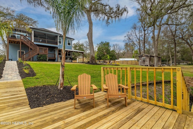 wooden deck featuring a shed, stairway, and an outdoor structure