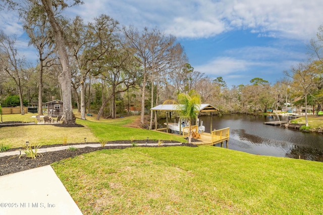 dock area with a water view and a lawn