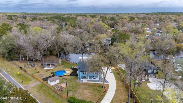 drone / aerial view featuring a forest view and a water view