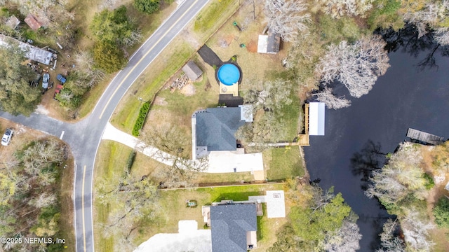 birds eye view of property with a water view