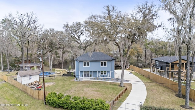 view of front of house with a porch, fence private yard, and a front lawn