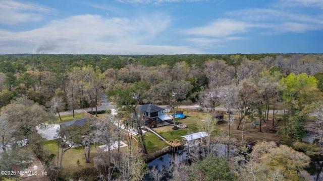 bird's eye view with a wooded view