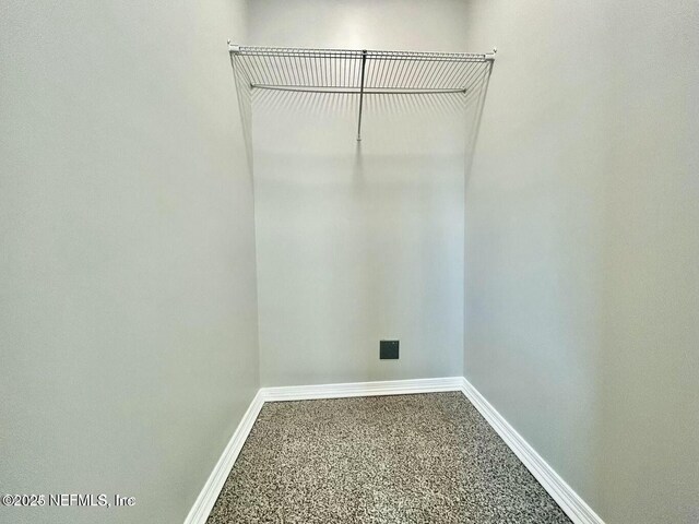 walk in closet with carpet