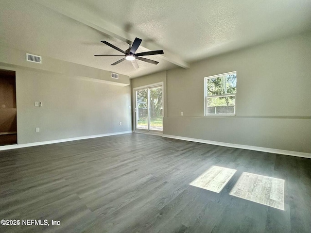 spare room featuring baseboards, visible vents, a textured ceiling, and wood finished floors