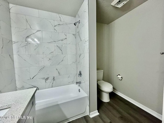 full bathroom with toilet, washtub / shower combination, vanity, wood finished floors, and baseboards