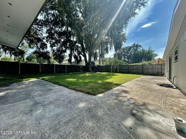 view of yard featuring a patio and a fenced backyard