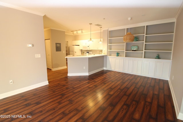 empty room with ornamental molding, dark wood-style flooring, visible vents, and baseboards