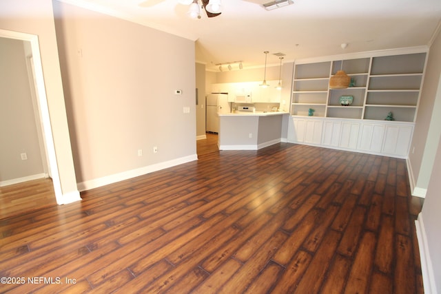 unfurnished living room with dark wood-style floors, ceiling fan, ornamental molding, and baseboards