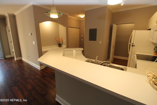 kitchen with electric panel, arched walkways, dark wood-style floors, ornamental molding, and a peninsula