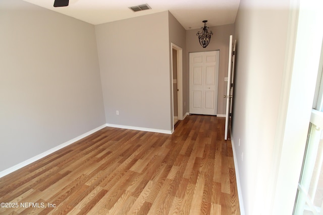 interior space with light wood finished floors, baseboards, and visible vents