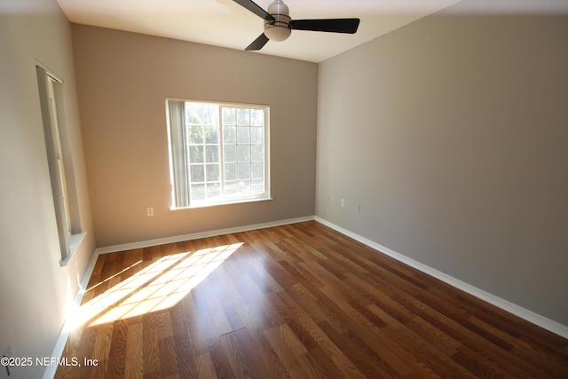 unfurnished room with ceiling fan, baseboards, and wood finished floors