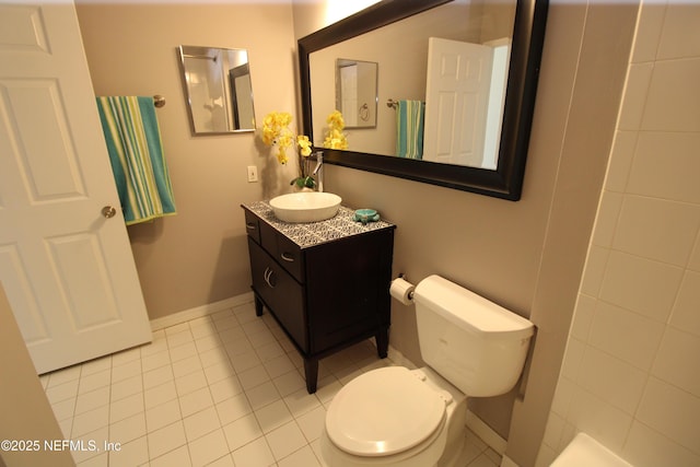 bathroom featuring tile patterned flooring, vanity, toilet, and baseboards