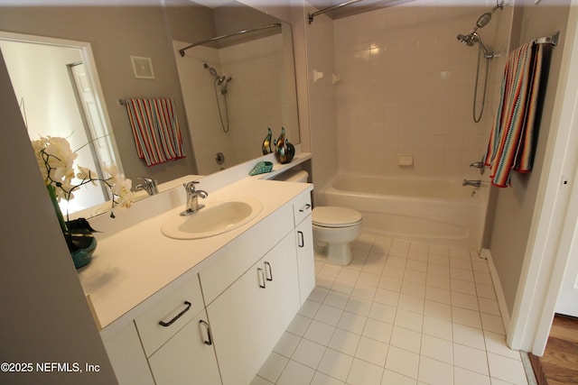 bathroom featuring toilet, shower / bathing tub combination, vanity, and tile patterned floors