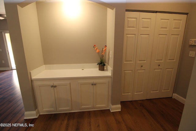 bathroom featuring baseboards and wood finished floors