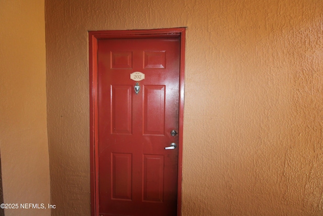 view of exterior entry featuring stucco siding