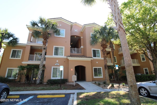 view of property featuring uncovered parking