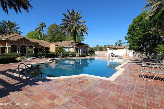 community pool featuring a patio area and fence