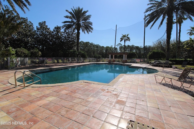 pool featuring a patio area and fence