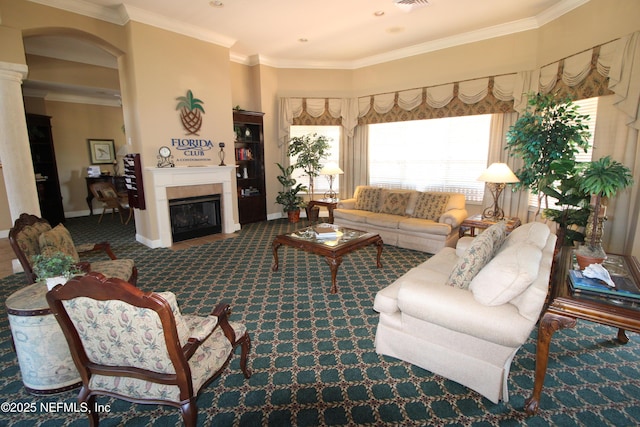 carpeted living room featuring ornamental molding, a glass covered fireplace, visible vents, and baseboards