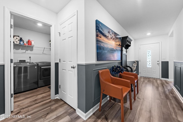 interior space with recessed lighting, washer and dryer, and wood finished floors