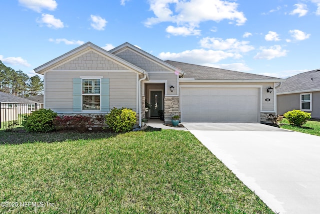 view of front facade with concrete driveway, an attached garage, and a front yard