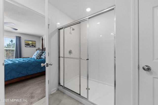 ensuite bathroom with tile patterned floors, connected bathroom, and a shower stall