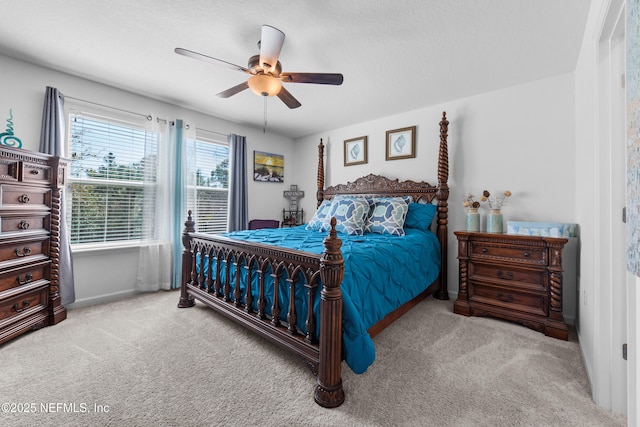 carpeted bedroom with a textured ceiling and ceiling fan