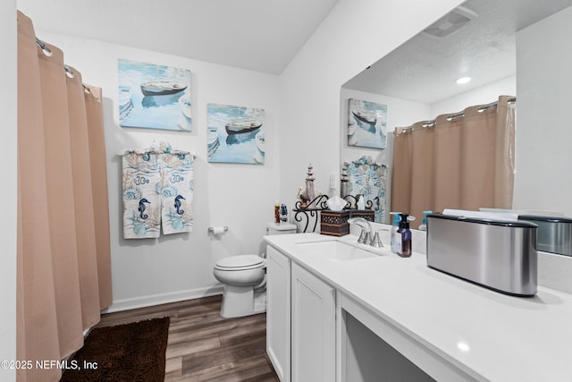 full bathroom with visible vents, baseboards, toilet, wood finished floors, and vanity