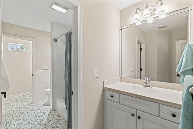 full bathroom featuring tile patterned floors, toilet, vanity, and shower / tub combo