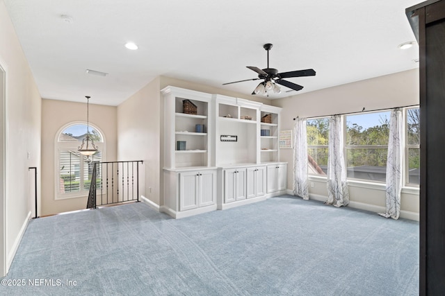 spare room featuring a healthy amount of sunlight, carpet floors, and ceiling fan