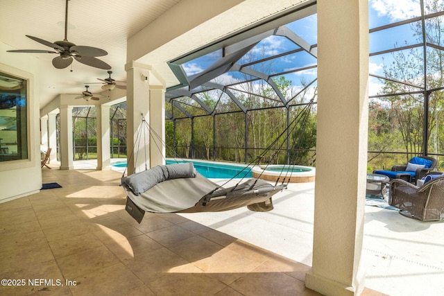 view of patio / terrace featuring a lanai, a pool with connected hot tub, and ceiling fan