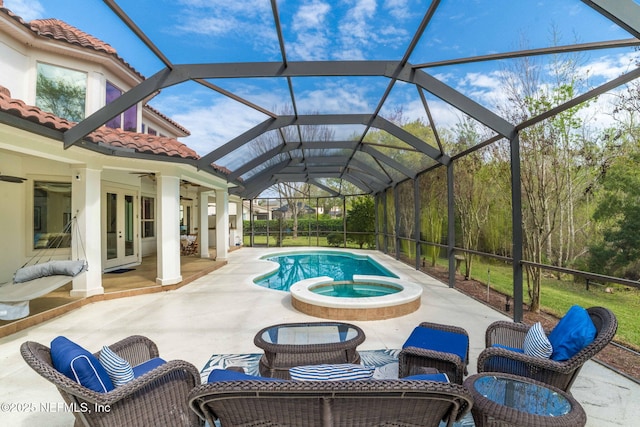 view of pool with french doors, a patio, a lanai, and a pool with connected hot tub