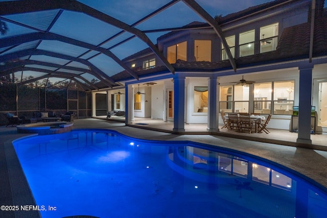 view of pool with a patio area, a lanai, a pool with connected hot tub, and a ceiling fan