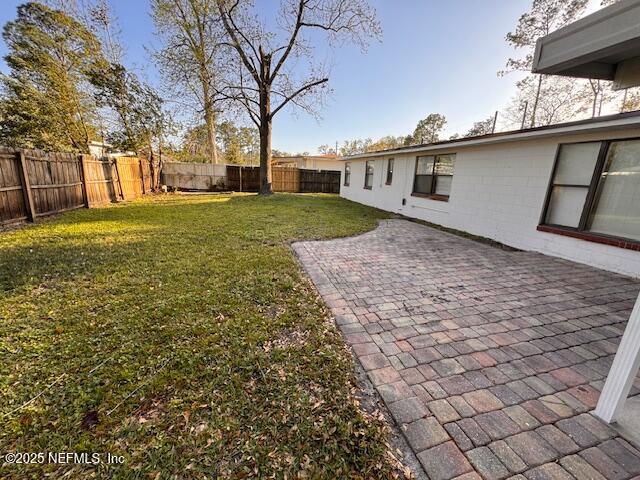 view of yard featuring a patio and a fenced backyard