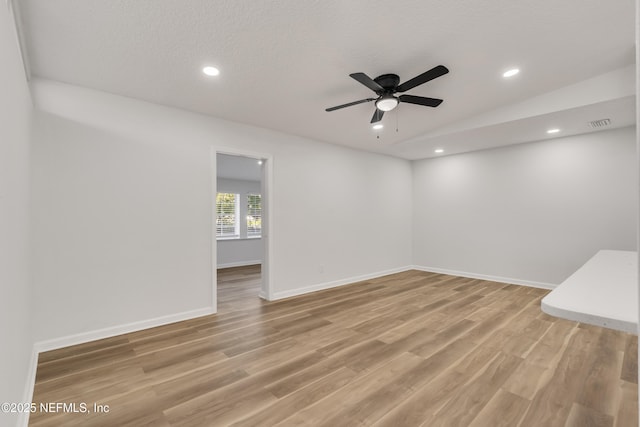 spare room featuring baseboards, light wood-type flooring, and recessed lighting