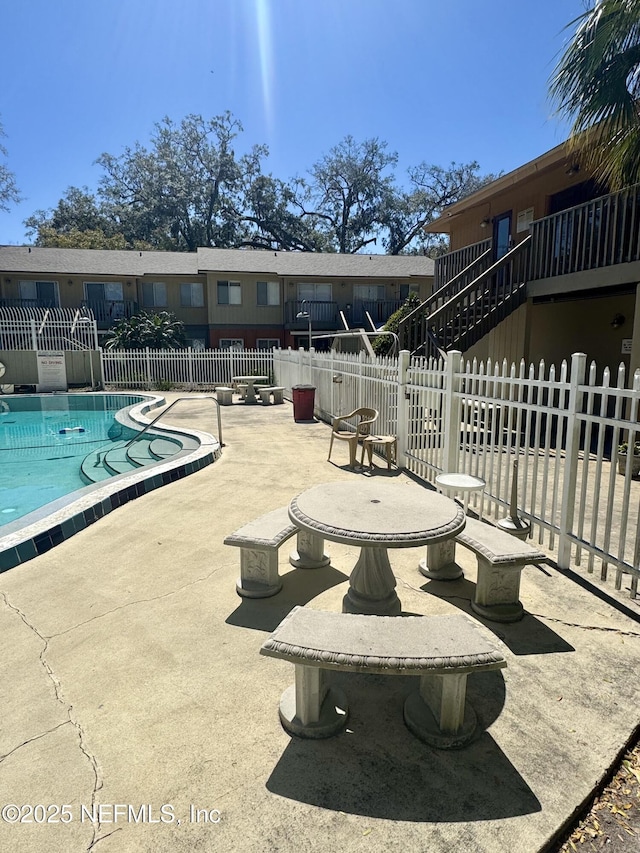 pool featuring a patio and fence