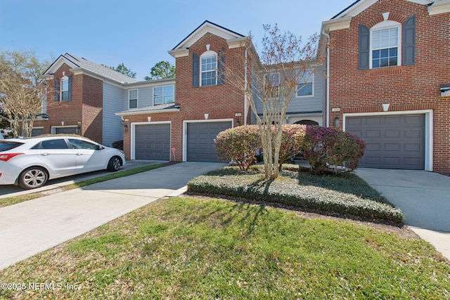 traditional-style house featuring driveway, brick siding, and an attached garage