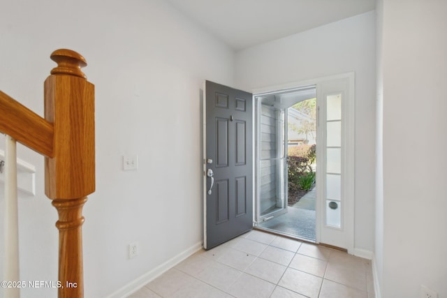 foyer entrance featuring baseboards and light tile patterned floors