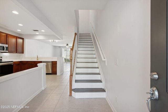 stairway featuring recessed lighting, baseboards, ceiling fan, and tile patterned floors