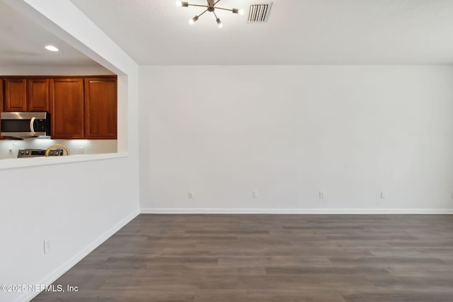 unfurnished dining area with dark wood-style floors, recessed lighting, visible vents, and baseboards