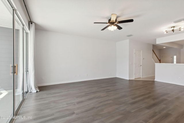 interior space featuring ceiling fan, visible vents, baseboards, stairs, and dark wood finished floors