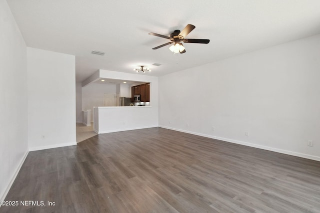 unfurnished living room with dark wood-style floors, ceiling fan, visible vents, and baseboards