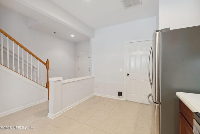 kitchen with baseboards, visible vents, freestanding refrigerator, light countertops, and recessed lighting