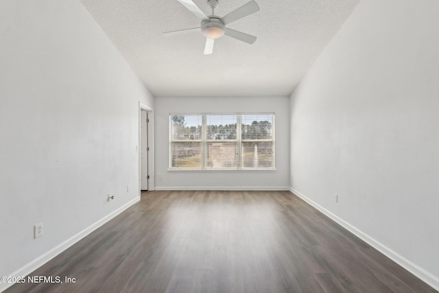 unfurnished room with dark wood-style floors, ceiling fan, baseboards, and a textured ceiling