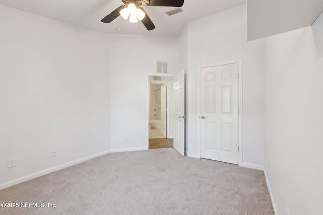 unfurnished bedroom with carpet floors, baseboards, visible vents, and connected bathroom